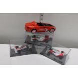 Three boxed die-cast Formula 1 models and a Snap-On car
