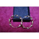 A pair of large 9ct gold twist hoop earrings