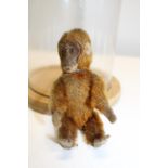 A 1920's Schuco Monkey scent bottle intact with stopper and display dome