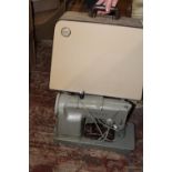 A cased vintage electric Singer sewing machine. collection only