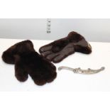 A pair of leather and fur gloves and a novelty dagger