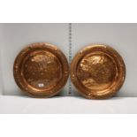 A pair of Arts and Crafts style copper chargers