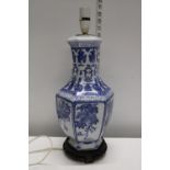 A Chinese blue and white ceramic lamp base on stand. Postage unavailable