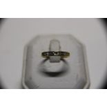 18ct gold channel set diamond ring with nine diamonds size N and a half total weight 2.70 grams