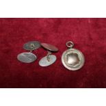 A hallmarked silver pendant and a pair of silver cufflinks