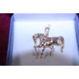 A gold plated horse pendant