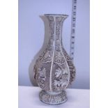 A ornate vase with hand decoration