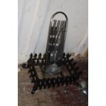 A cast iron fire grate and stainless steel companion set, postage unavailable