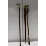 Three antique brass topped walking sticks, postage unavailable