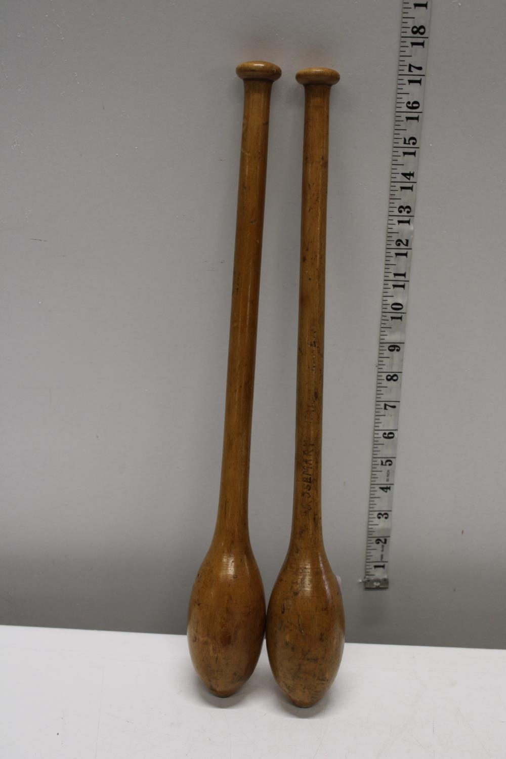 A pair of antique Elm juggling batons