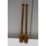 A pair of antique Elm juggling batons