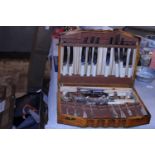 A wooden cutlery box and contents