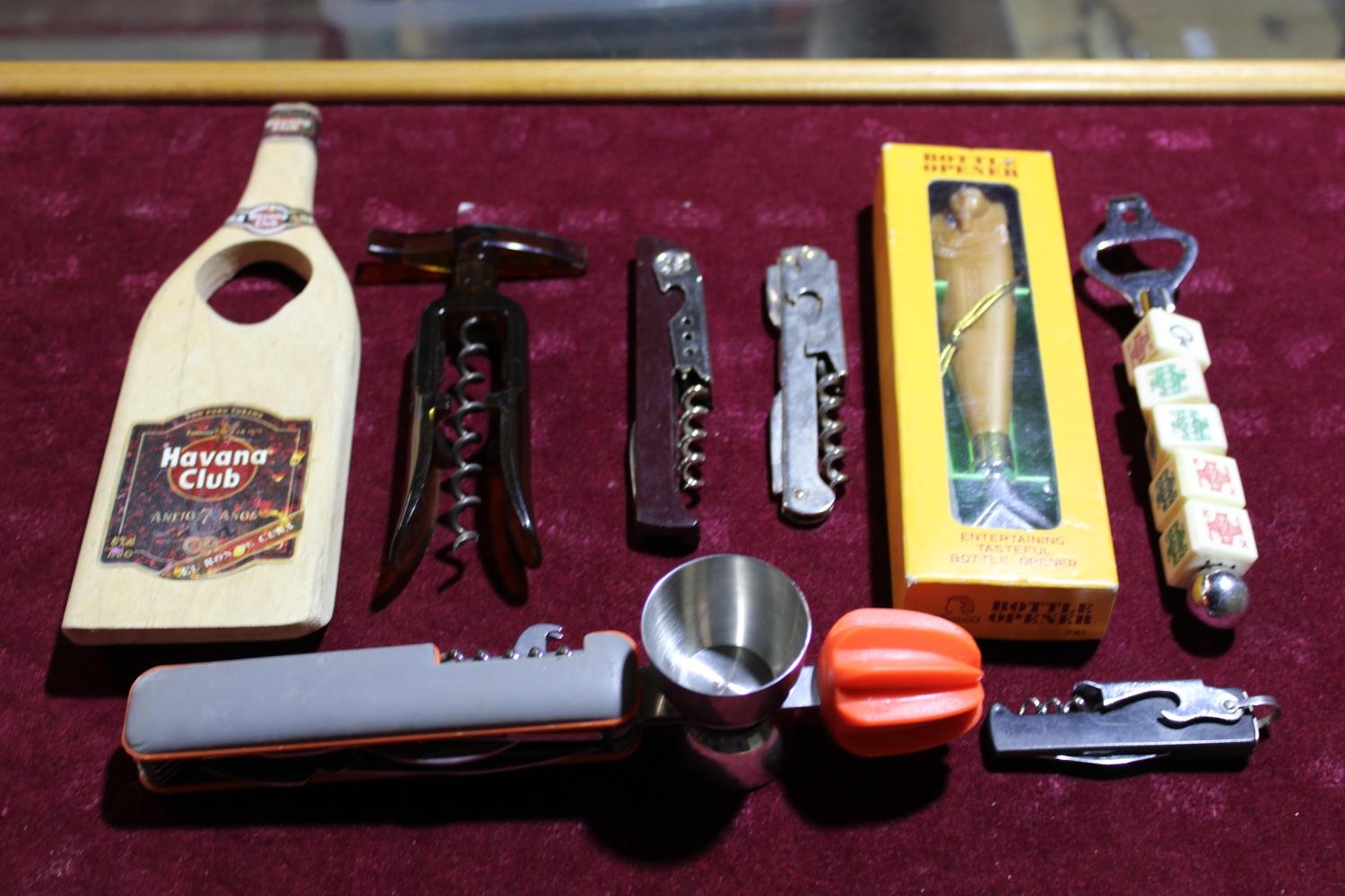 A job lot of novelty corkscrews and bottle openers