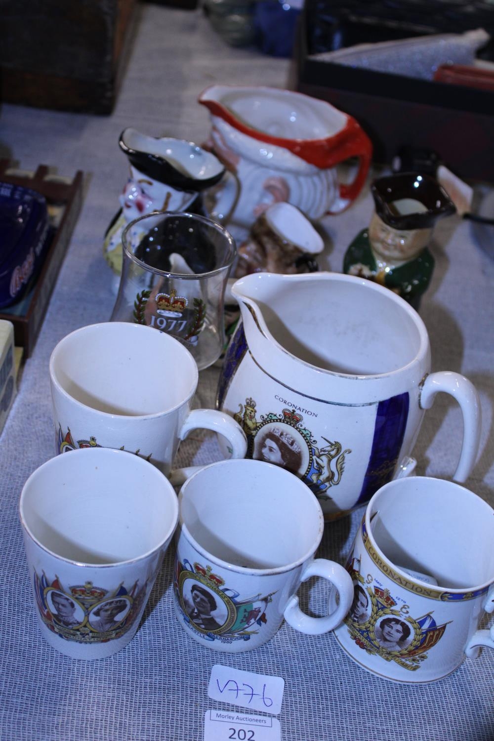 A large selection of commemorative ware and toby jugs