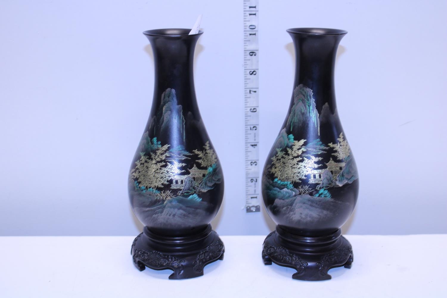 A pair of Oriental vases on stands