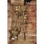 A set of brass fire dogs and companion set, postage unavailable
