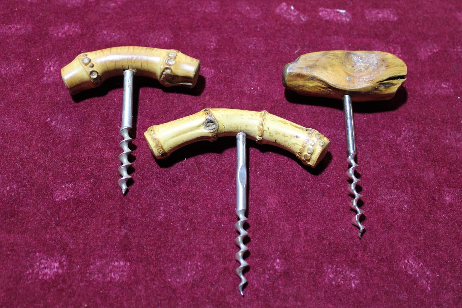 Three vintage corkscrews with wooden handles