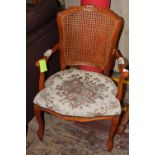 An upholstered rattan back arm chair. collection only