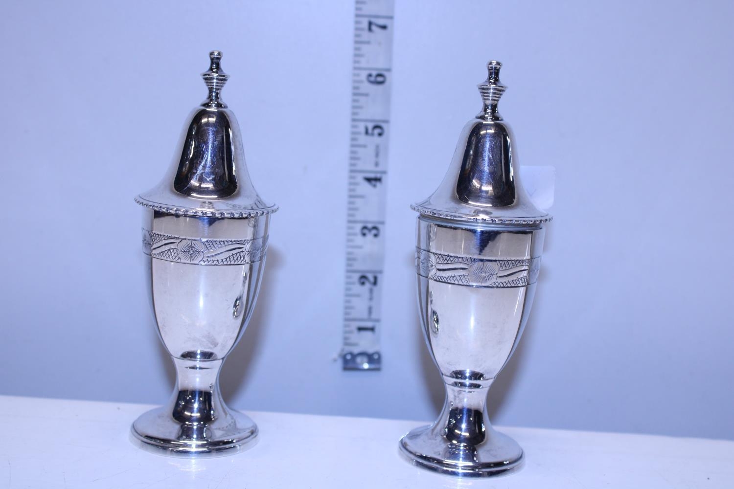 A pair of silver plated salt and pepper pots