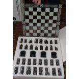 A boxed glass chess set and board