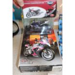 Three boxed die-cast motorbike models