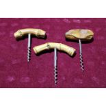 Three vintage corkscrews with wooden handles