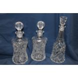 A pair of cut glass crystal decanters and one other