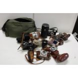 A job lot of assorted vintage cameras and accessories