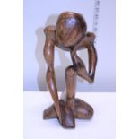 A hand carved contemporary wooden figure