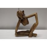 A hand carved contemporary wooden figure