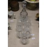 A cut glass crystal decanter and seven brandy balloons