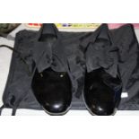 A pair of lightly worn patent shoes size 9.5