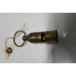 A reproduction brass Titanic whistle