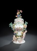 A MEISSEN FLORAL AND CUPIDO PATTERN POTPOURRI VASE AND COVER