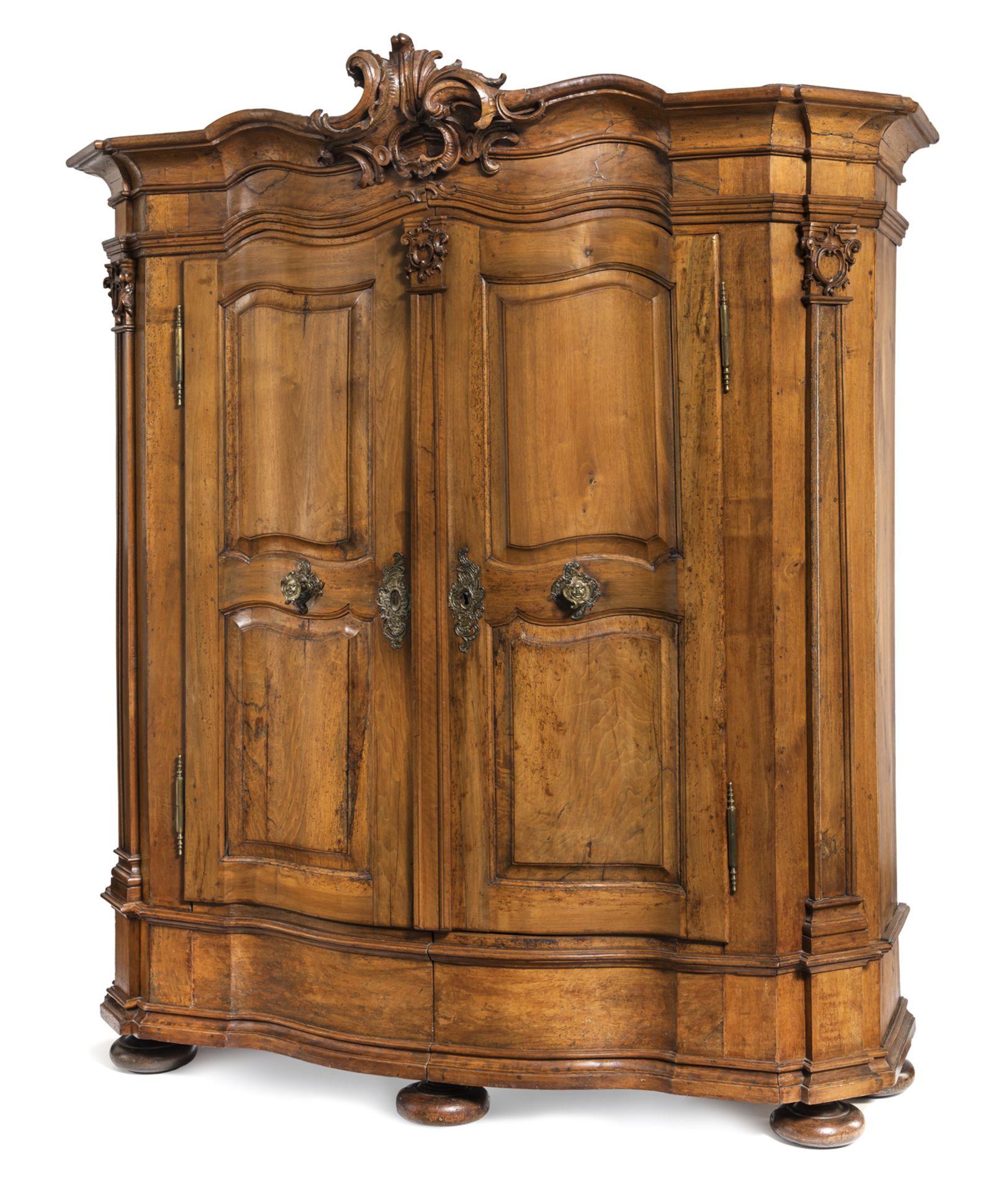 A LARGE BAROQUE BRASS MOUNTED CARVED WALNUT CUPBOARD