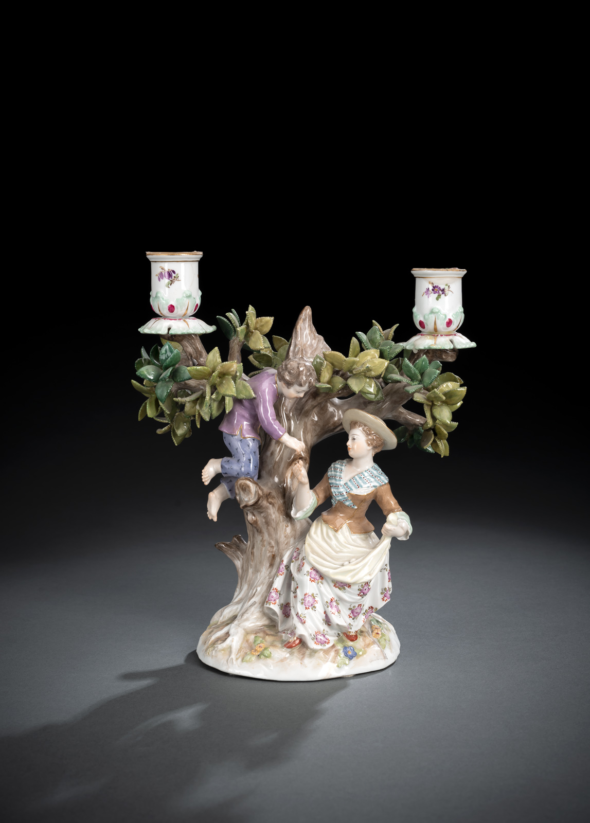 A MEISSEN FIGURAL AND TREE SHAPED TWO LIGHT CANDLESTICK