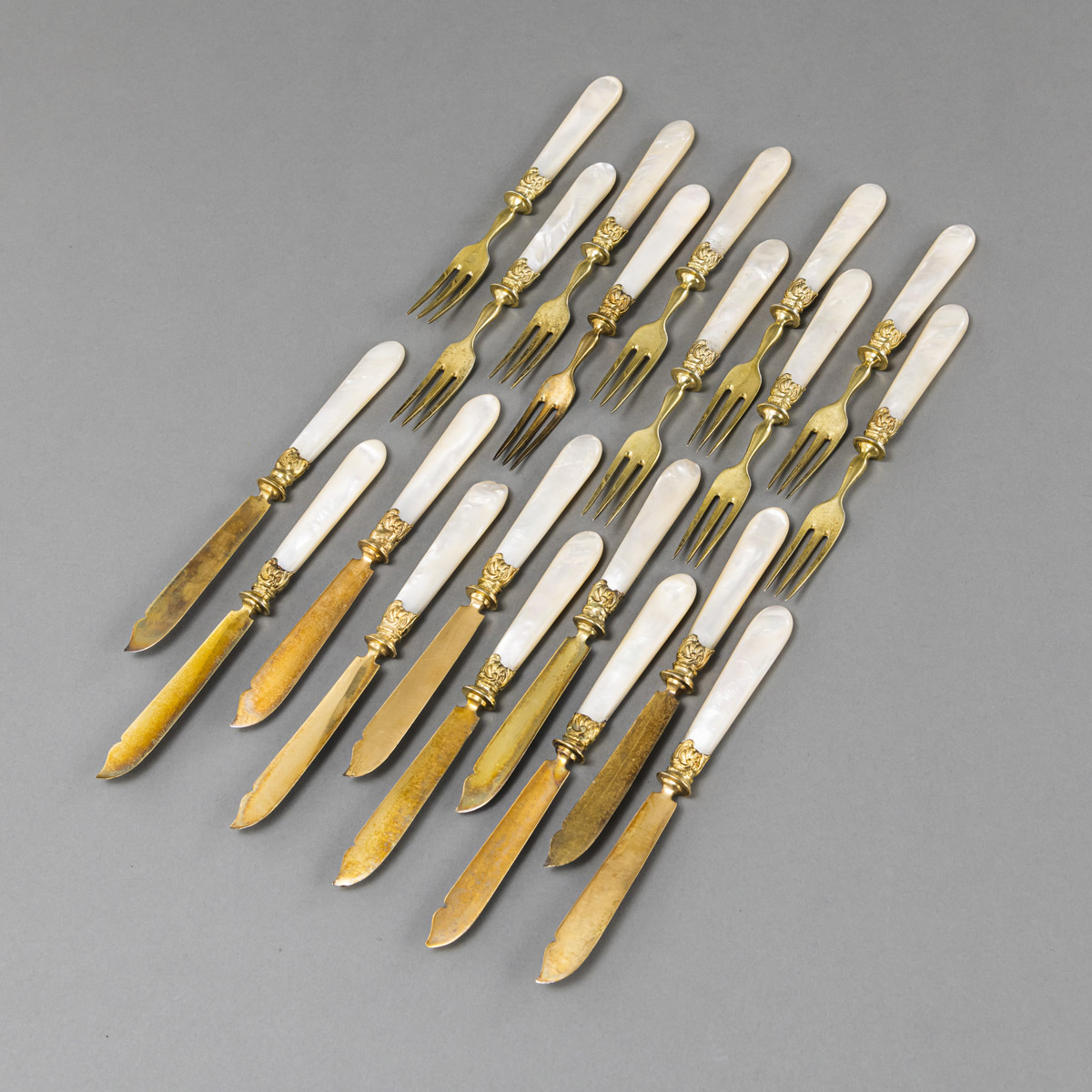 A GERMAN SILVERGILT AND MOTHER-OF-PEARL FRUIT CUTLERY FOR 10
