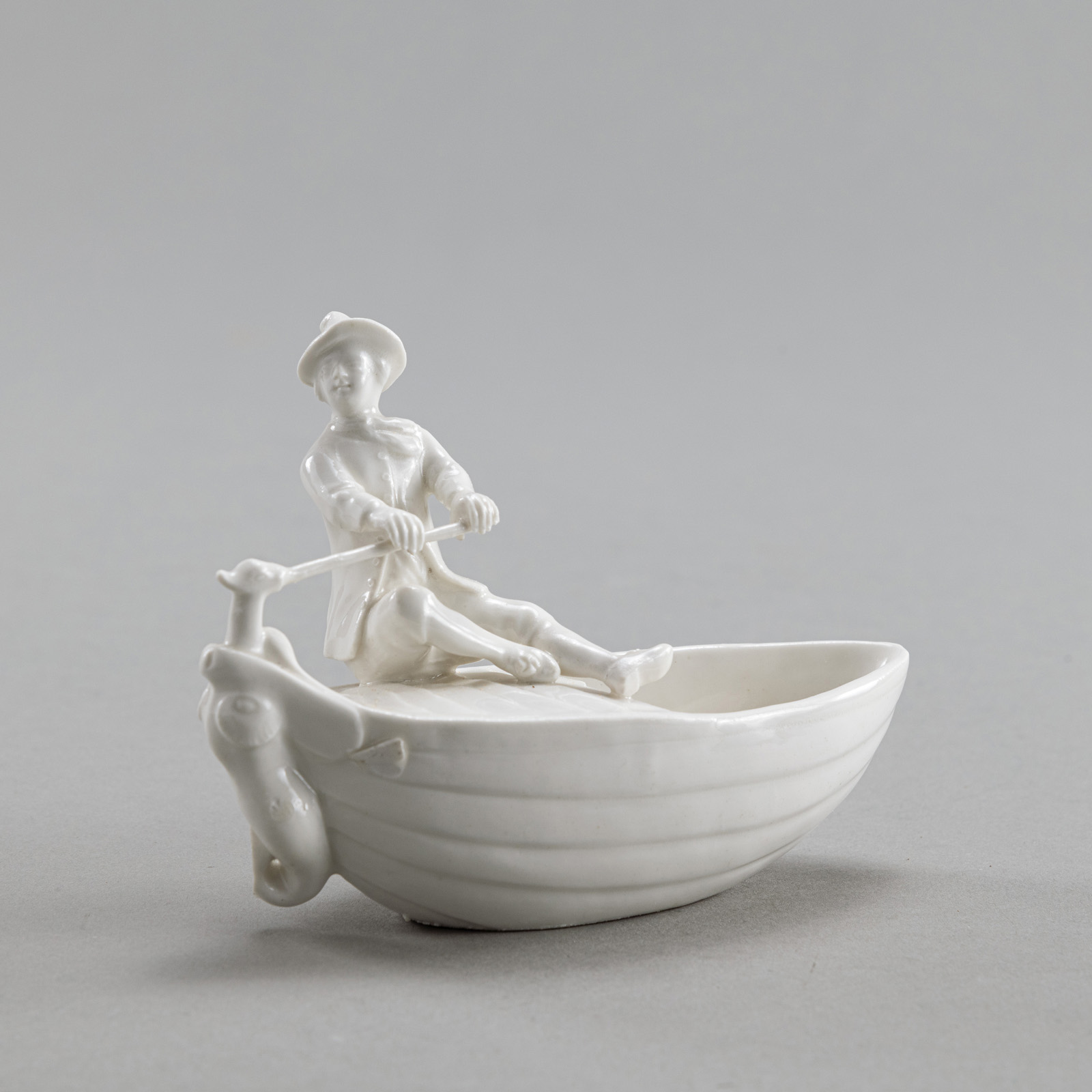 A GERMAN WHITE PORCELAIN SALT MODELLED AS A BOATMAN