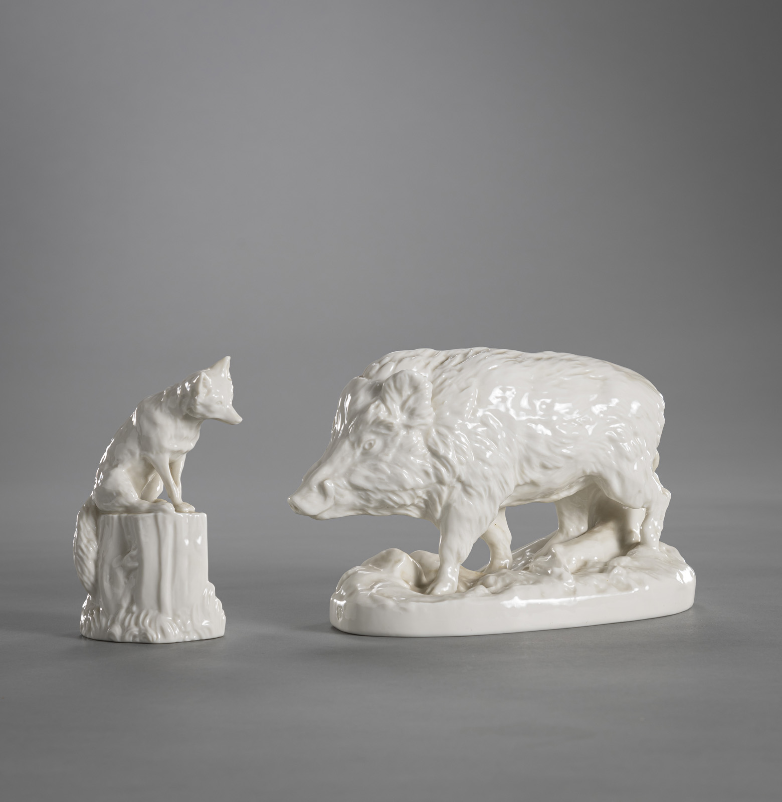 A NYMPHENBURG FIGURE OF A WILD BOAR AND A FOX