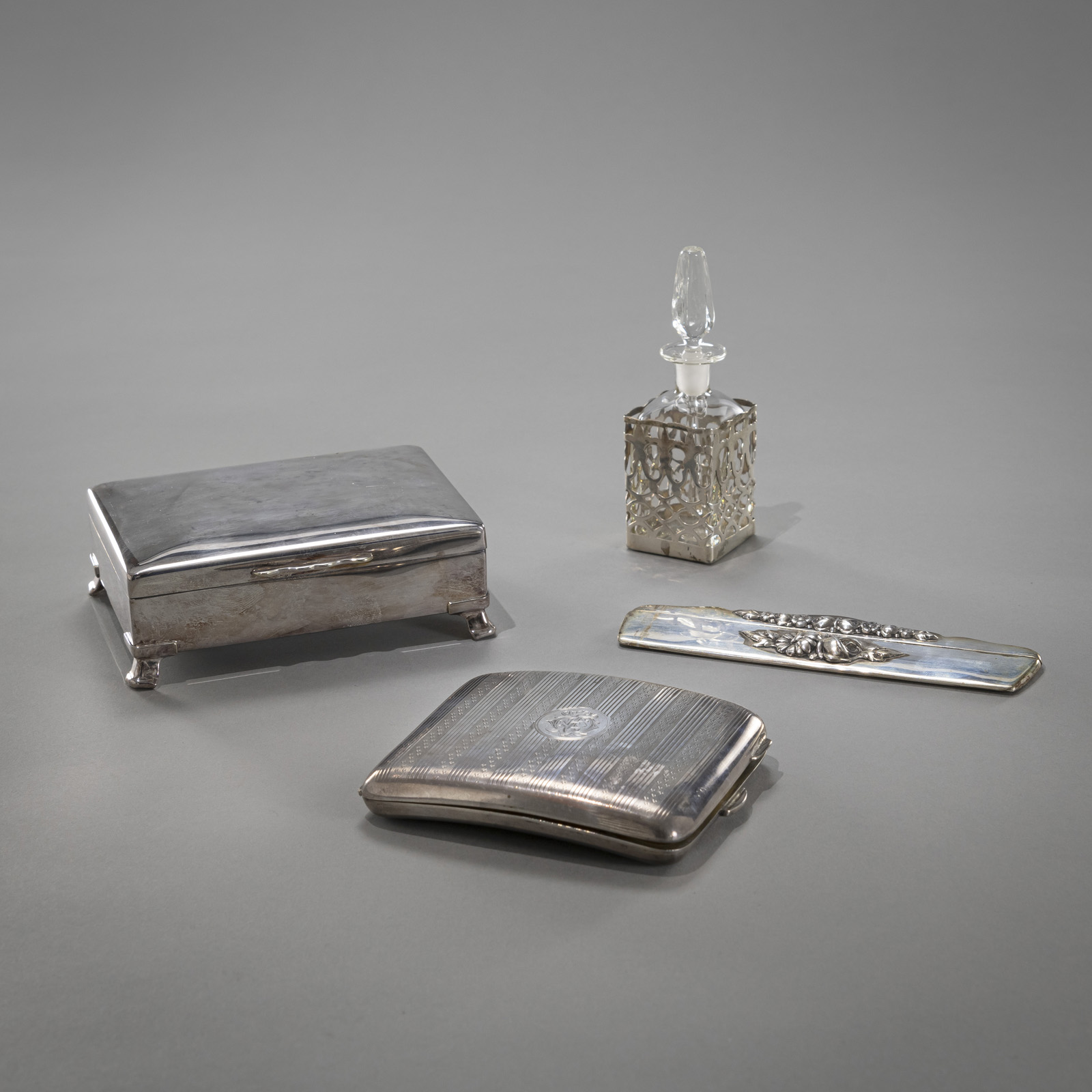 TWO CIGARETTE CASES; A PERFUME FLACON AND A COMB