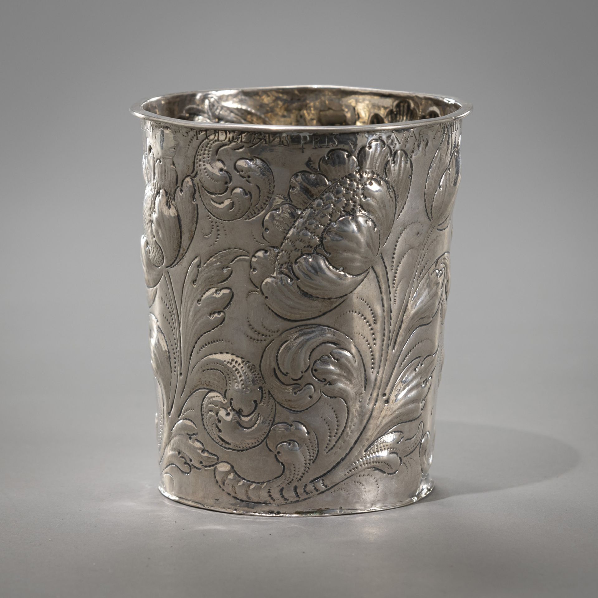 A FLORAL TOOLED BAROQUE BEAKER