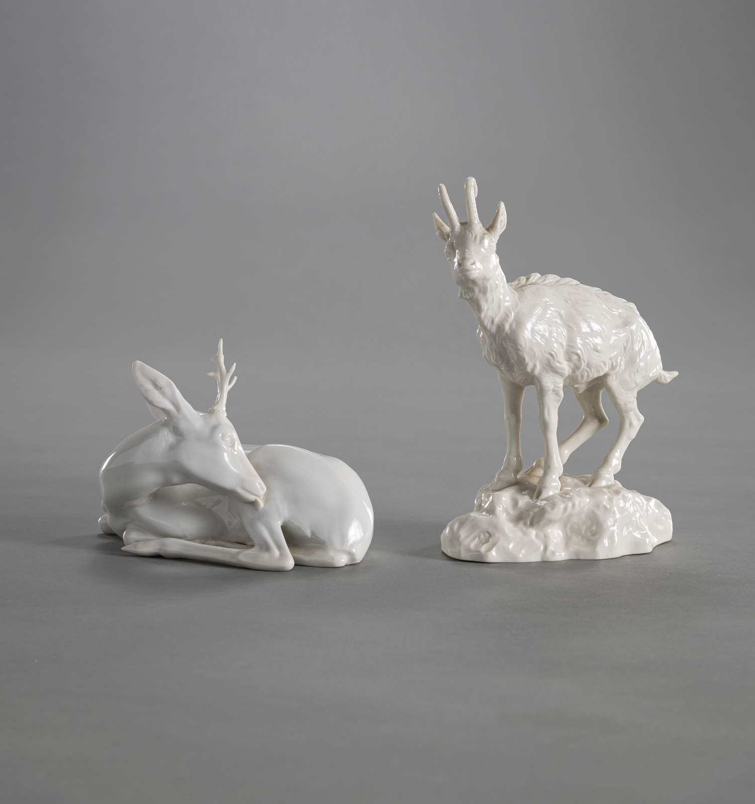 A NYMPHENBURG WHITE PORCELAIN FIGURE OF A CHAMOIS AND A ROEBUCK