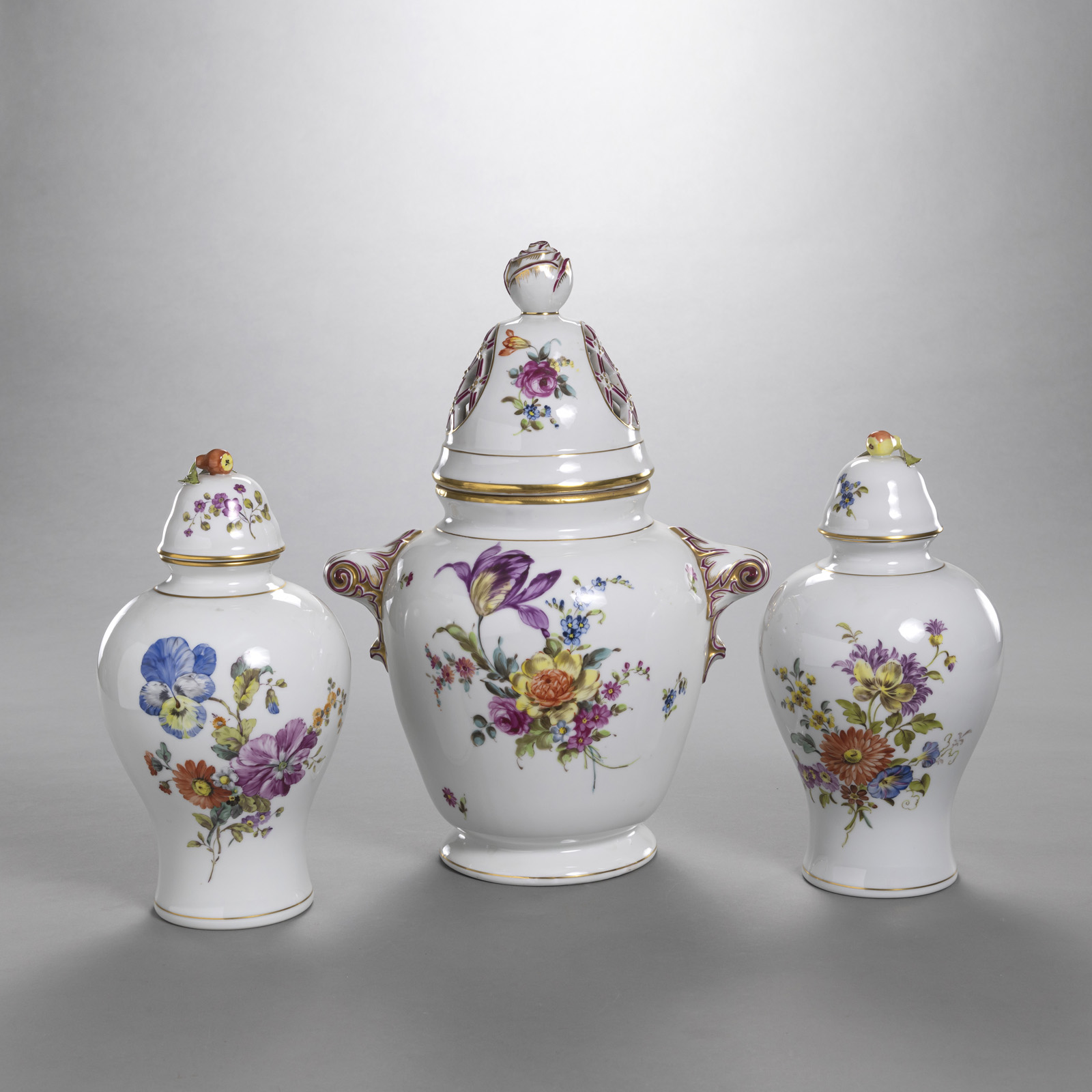 THREE FLORAL TOOLED PORCELAIN VASES AND LIDS