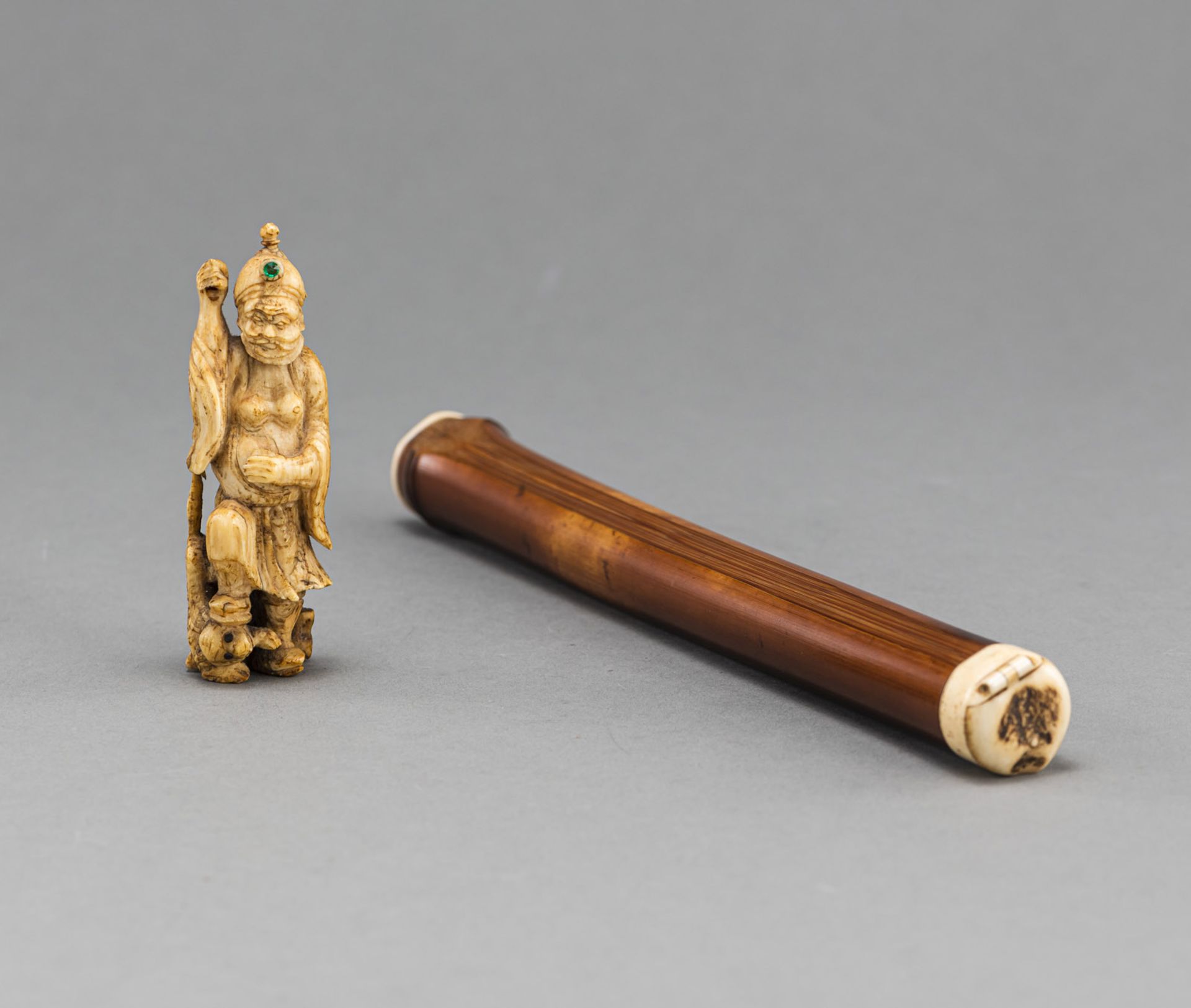 A SMALL DEER HORN CARVING OF BOSHÔ WITH TIGER AND A BAMBOO BRUSH HOLDER WITH BRUSH