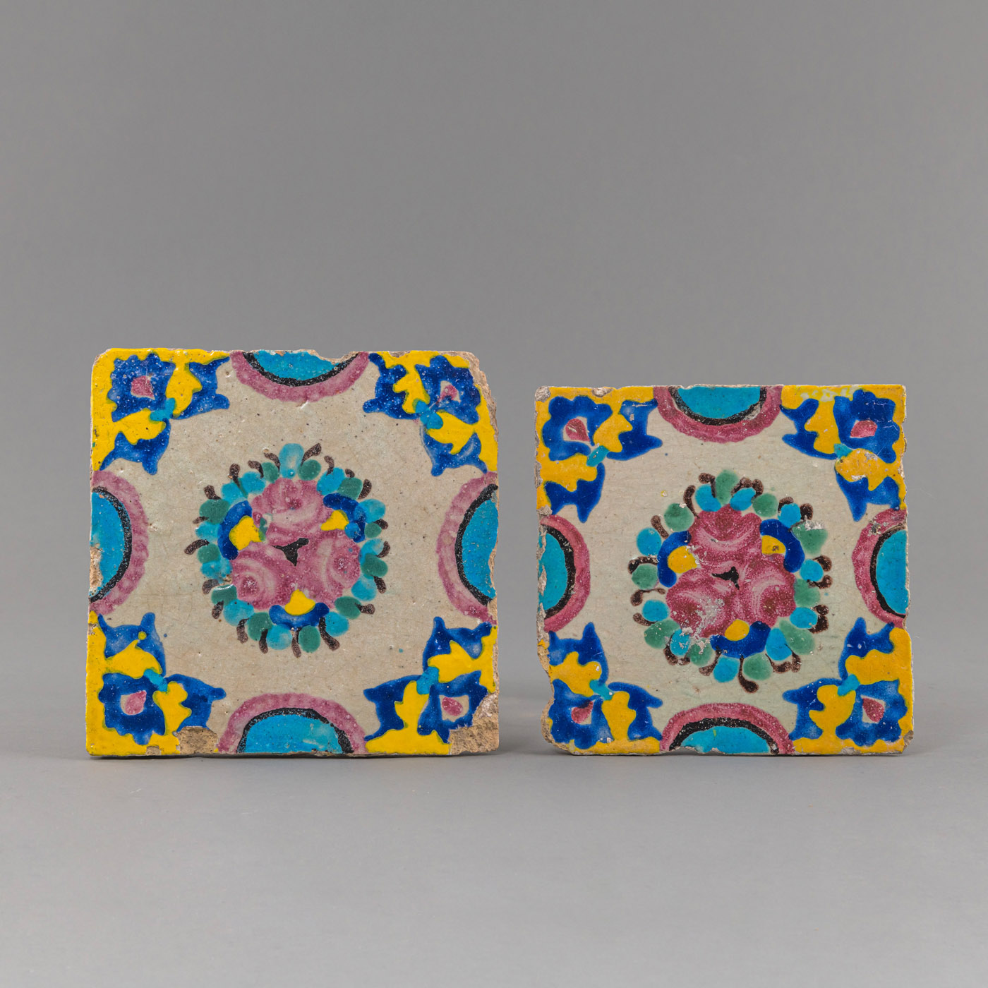 TWO POLYCHROME POTTERY TILES WITH FLOWERS DECORATION