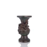 A BRONZE VASE WITH A SCULPTURAL DRAGON OVER WAVES