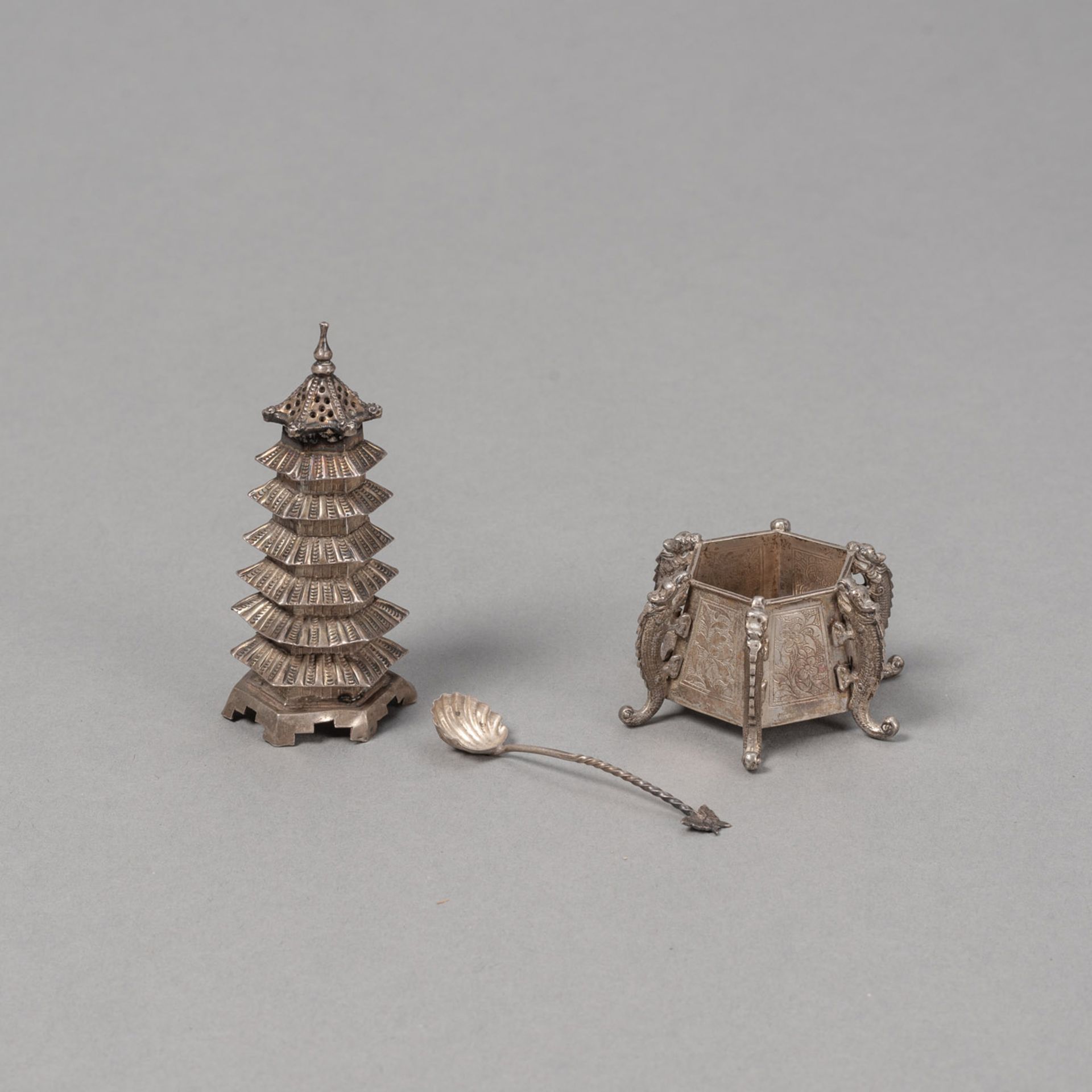 A SILVER SALT SHAKER IN THE SHAPE OF A PAGODA WITH COVER AND A SMALL BOWL WITH A SPOON