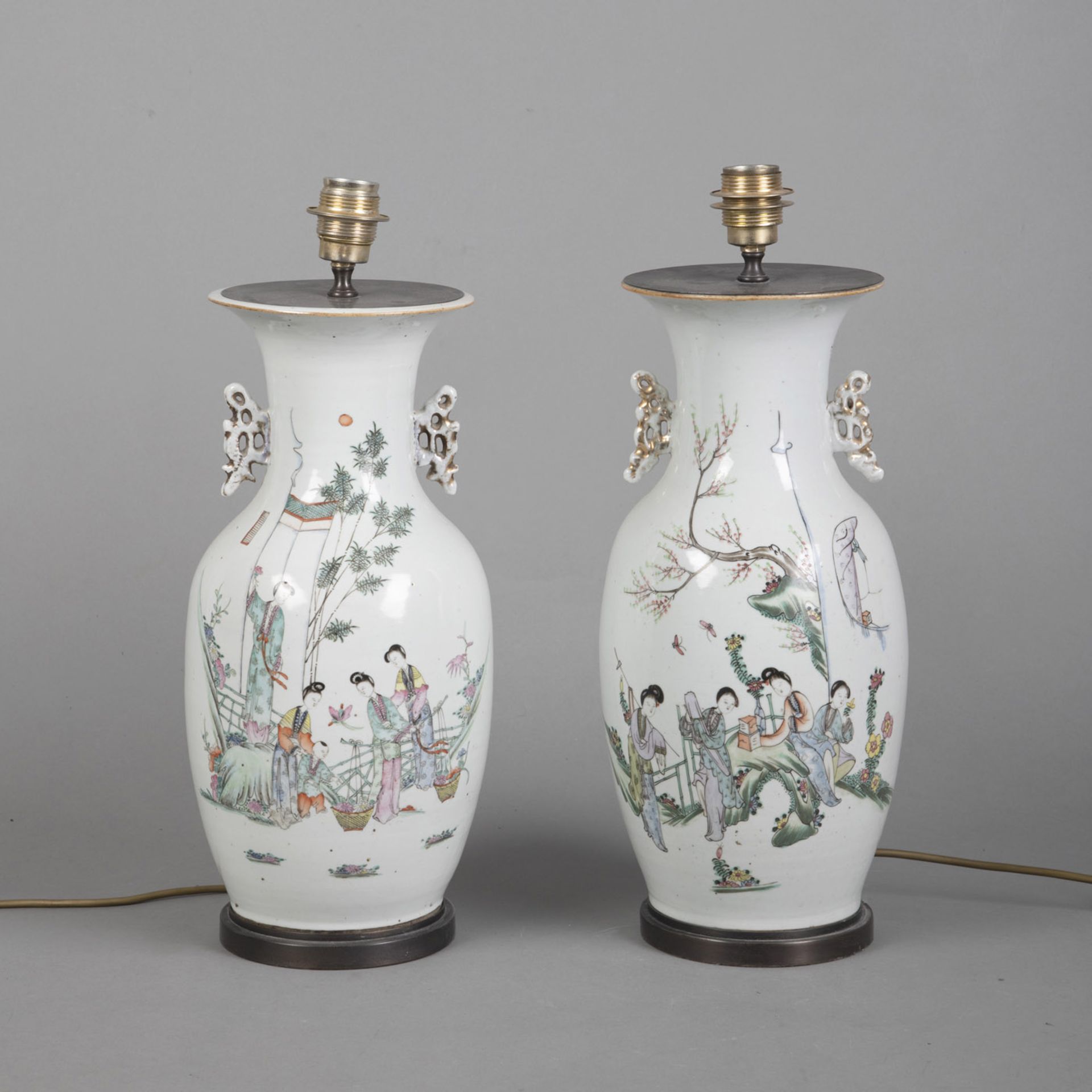 A PAIR OF POLYCHROME PAINTED PORCELAIN VASES DEPICTING LADIES IN A GARDEN, MOUNTED AS LAMPS