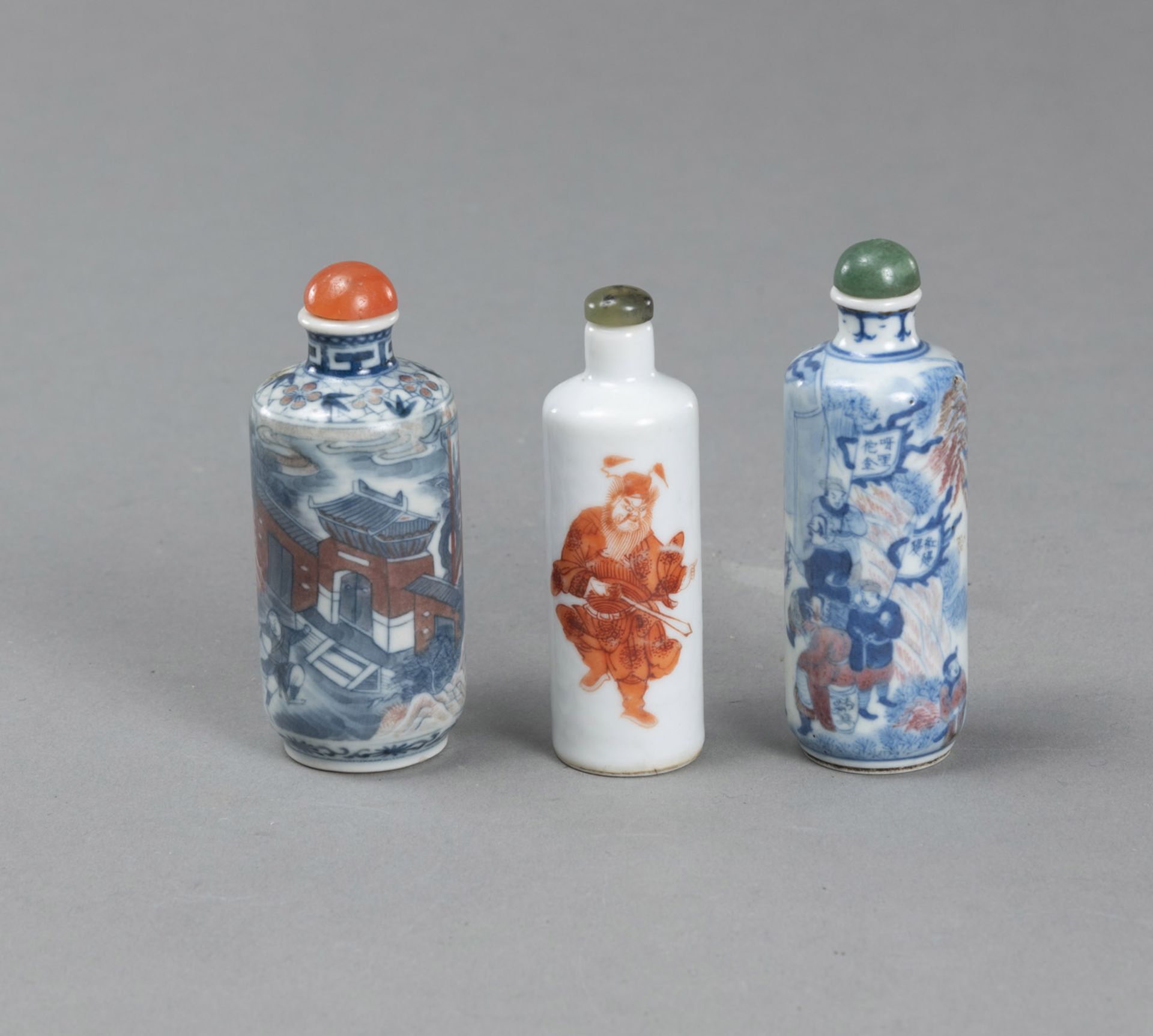 THREE UNDERGLAZE-BLUE AND IRON-RED DECORATED PORCELAIN SNUFFBOTTLES