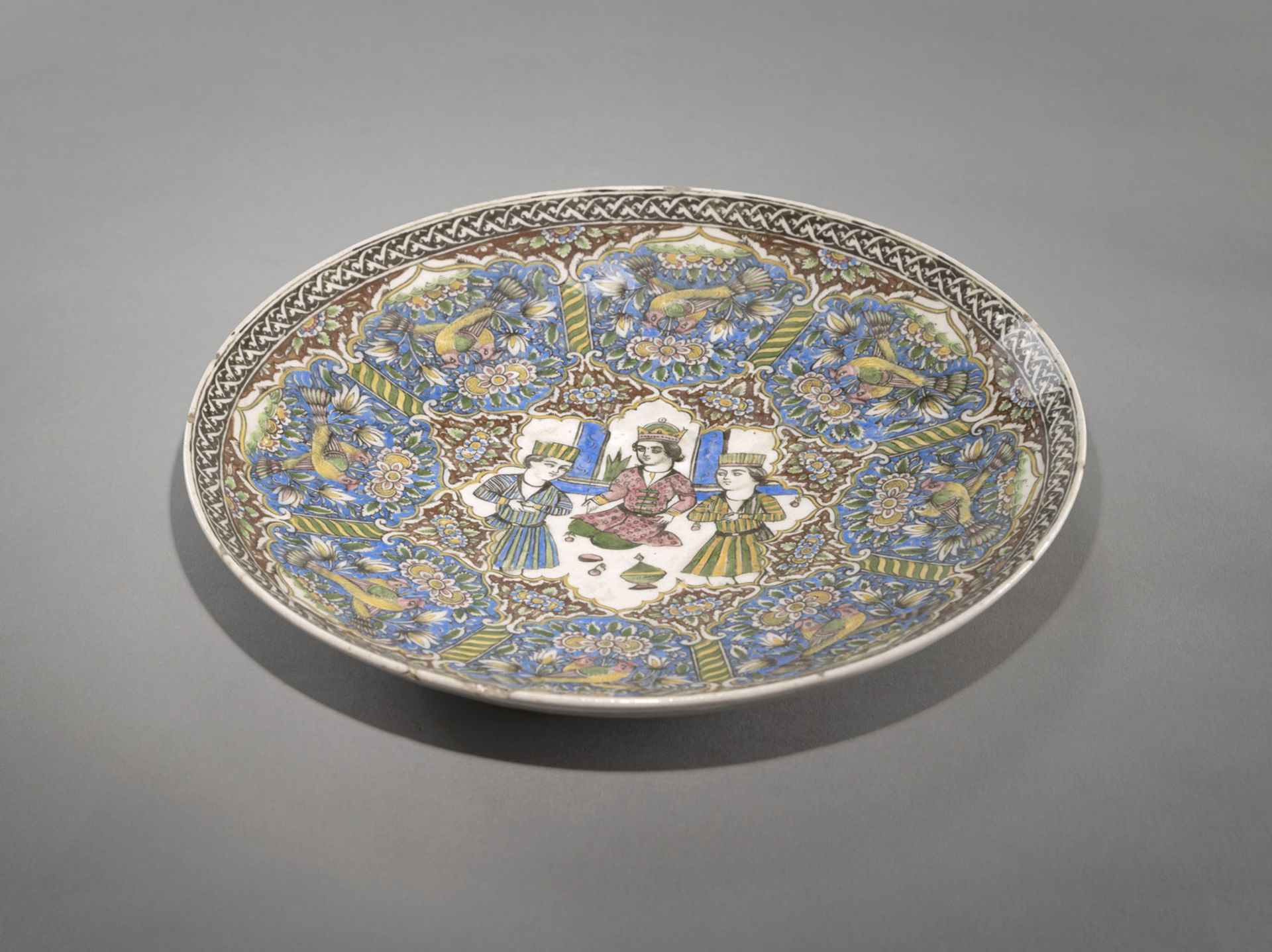 A QAJAR GLAZED POTTERY DISH WITH FINE DECORATION OF FIGURES, ANIMALS AND FLOWERS - Image 2 of 4